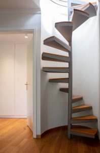Spiral interior staircase, modern revolving staircase metal structure, wooden stairs. Minimal design